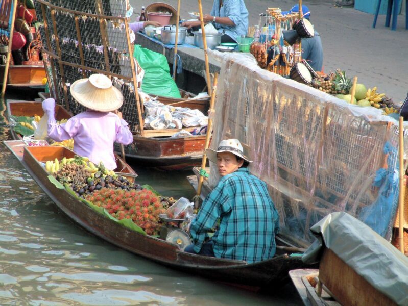 A local seller with fruits in Floating Market Bangkok