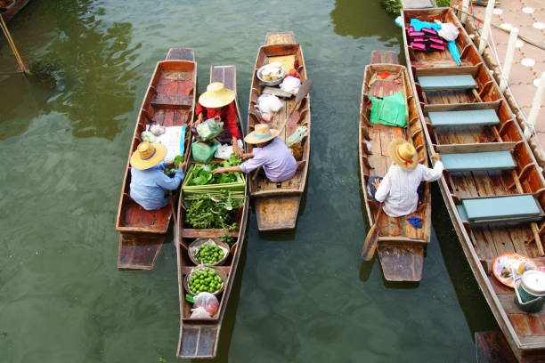 Locals in historic floating market bangkok