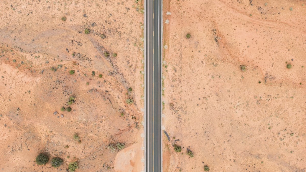 an aerial view of two roads in the desert