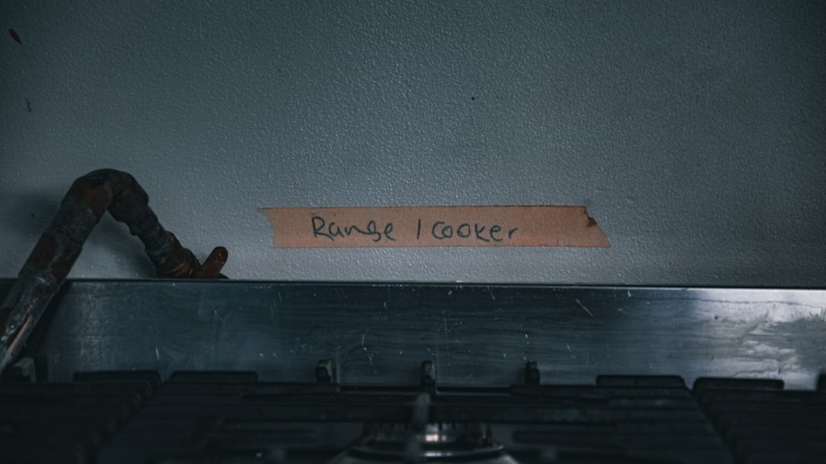 a close up of a stove with a sign on it