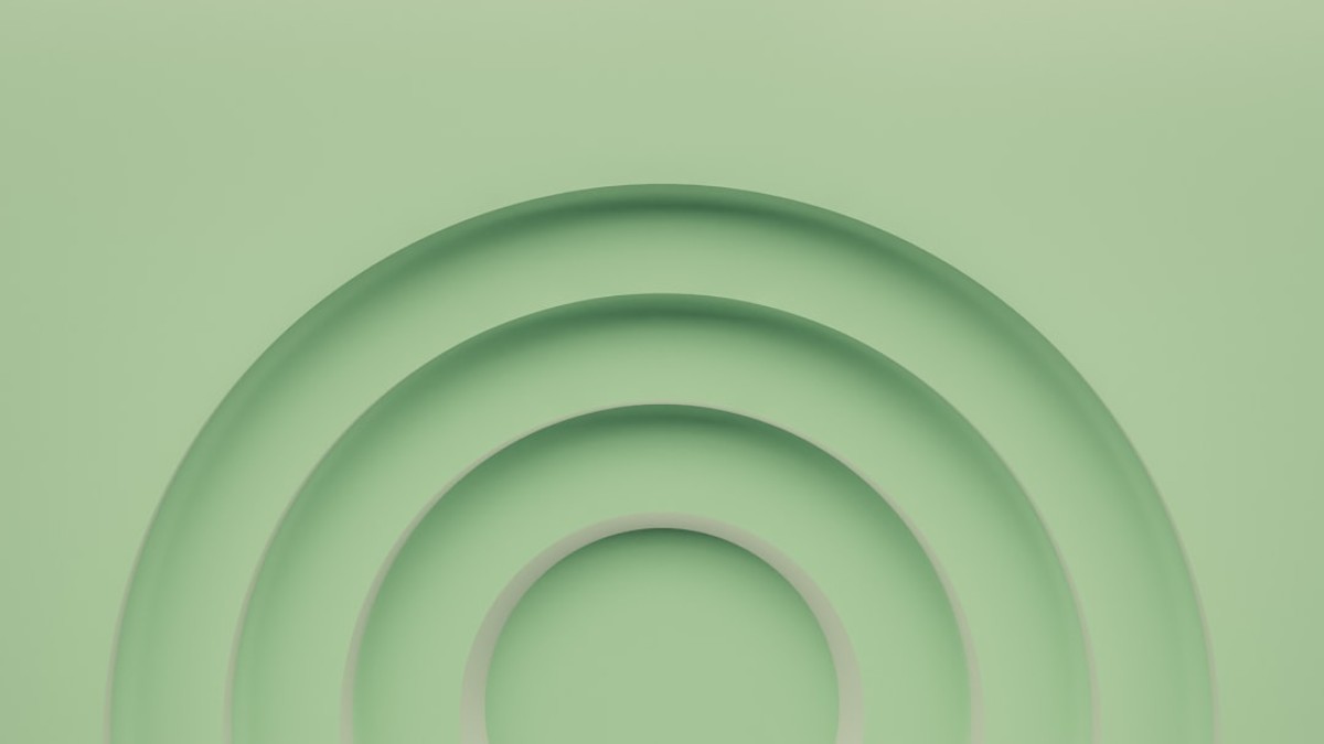 a green background with a circular design in the center