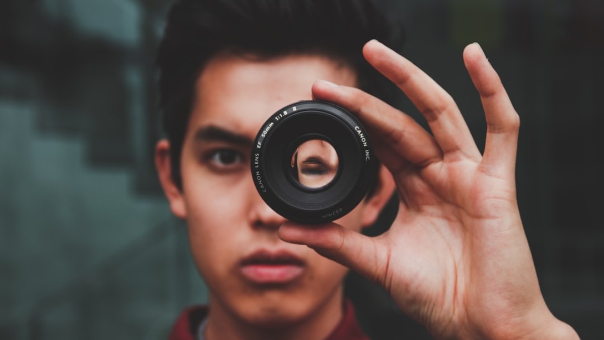 selective focus photography of man wearing red top