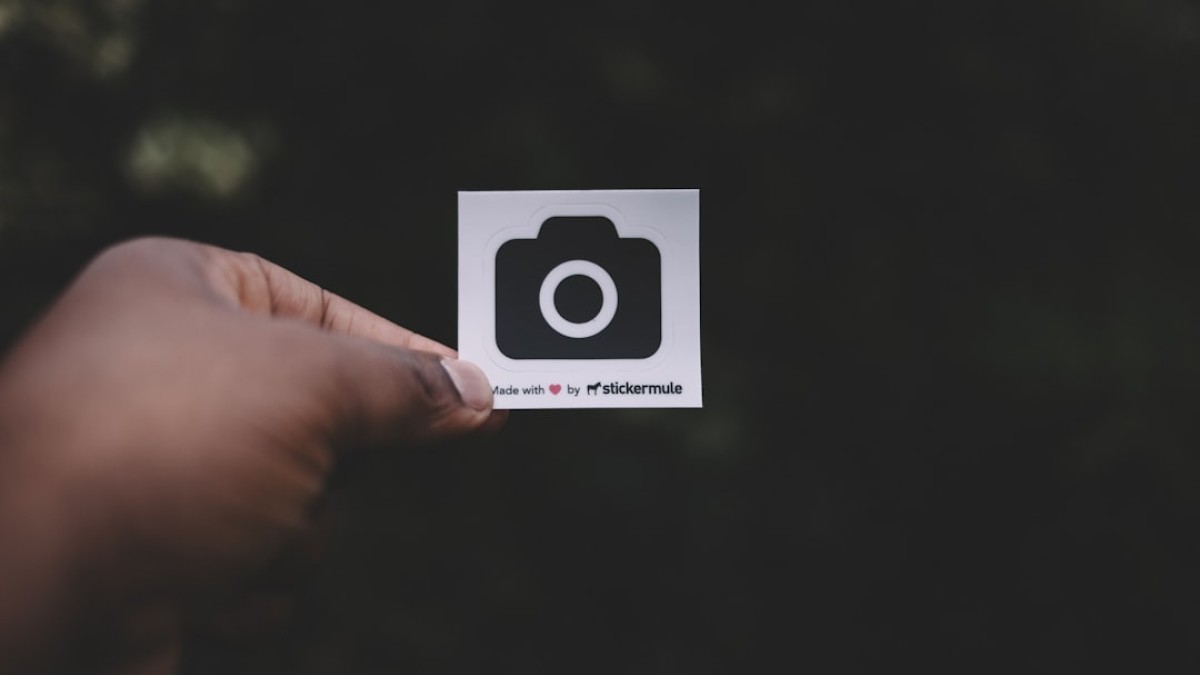 person holding white paper showing camera illustration