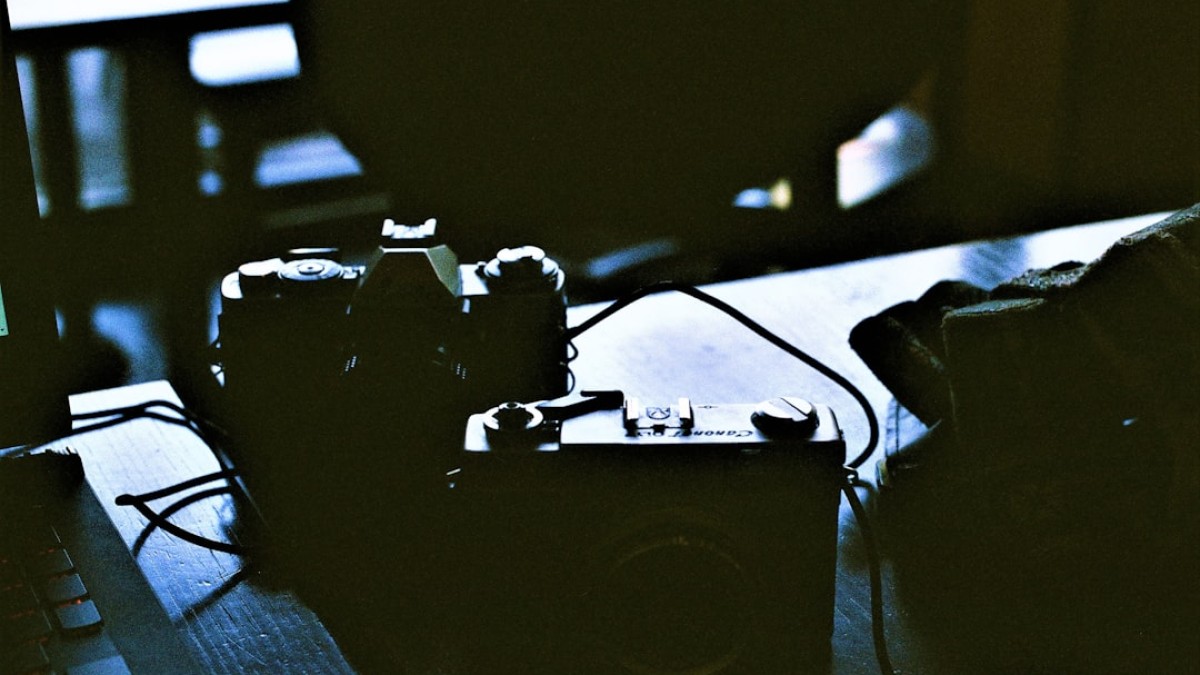 a couple of cameras sitting on top of a table