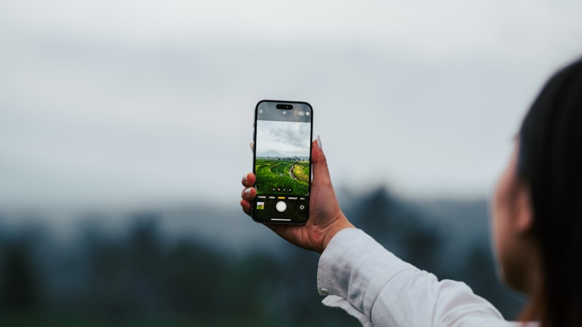 a woman taking a picture with her cell phone