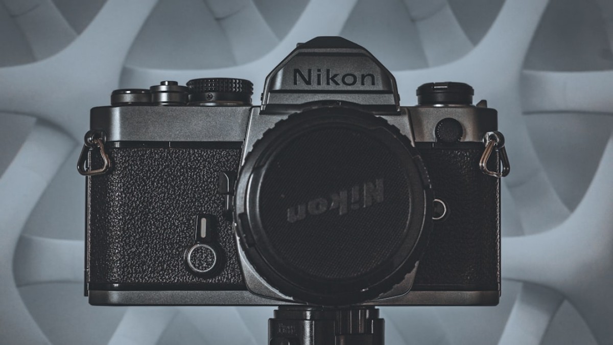 black nikon dslr camera on white table