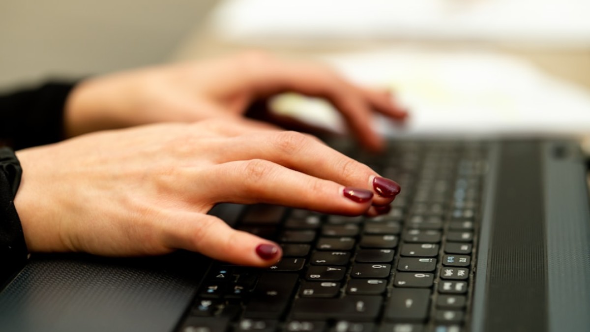 persons hand on black laptop computer