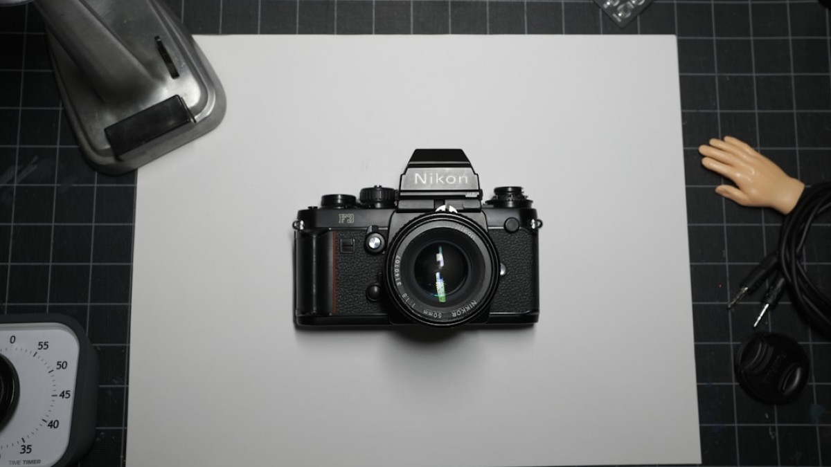 black nikon dslr camera on white table