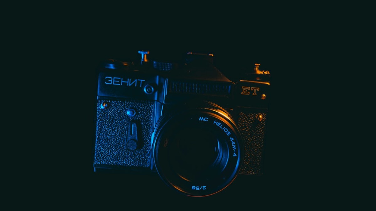 black nikon dslr camera on white surface