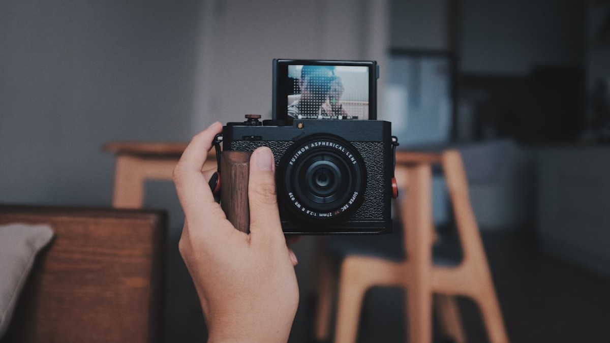 a person holding a camera up to take a picture