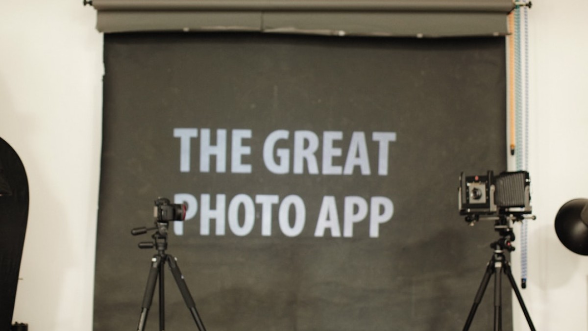 a camera and tripod set up in front of a sign