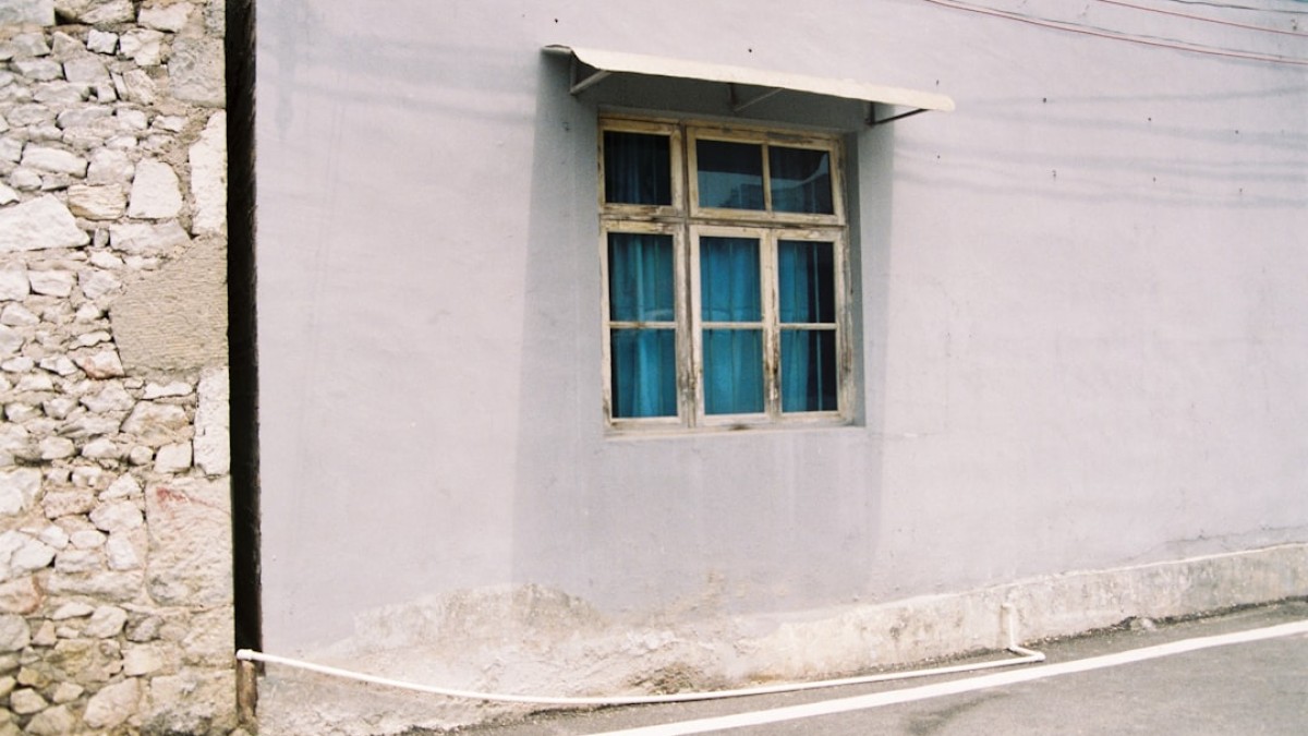 a white building with a blue window on the side of it