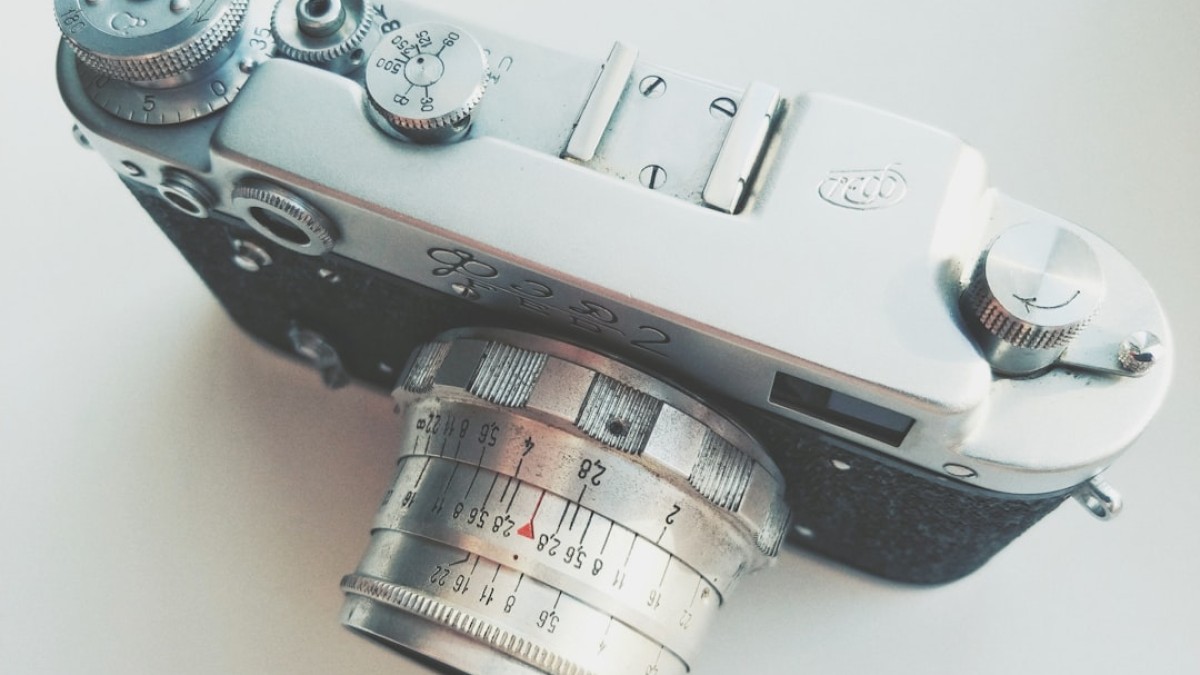 silver and black camera on white table